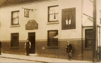 The Four Horse Shoes Public House on King Street, Alfreton. John Walter Clarke was the Publican at the time, who is listed in Kelly's Directory as the landlord in 1912 and 1925. It could be him standing in the doorway, but this is not certain.