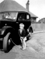 Norman Vertigan pumping up his fathers car tyre