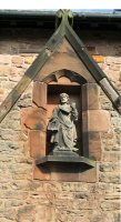 Statue over Main Door of St. Thomas, this statue was moved from the original Chapel building to its present position on the Church