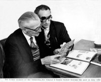 Former workers at Riddings Ironworks, Ben Simpson and Dennis Walker looking at old photographs and discussing the past in July 1982