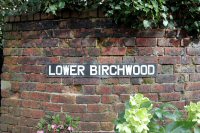 Old street sign for Lower Birchwood, attached to a wall on Cockshut Lane 2018.