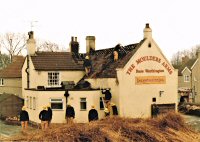 Firemen on the roof of the Moulders Arms Riddings after removing the thatch due to a Fire ion the main building date not known.