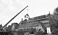 Bowmer & Kirkland crane lifting new roof supports into place after the Church fire in 1984.