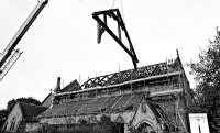 Bowmer & Kirkland crane lifting roof support onto the Church roof during the rebuilding after the fire in 1984.