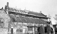 The roof being re-tiled after the fire in 1984.